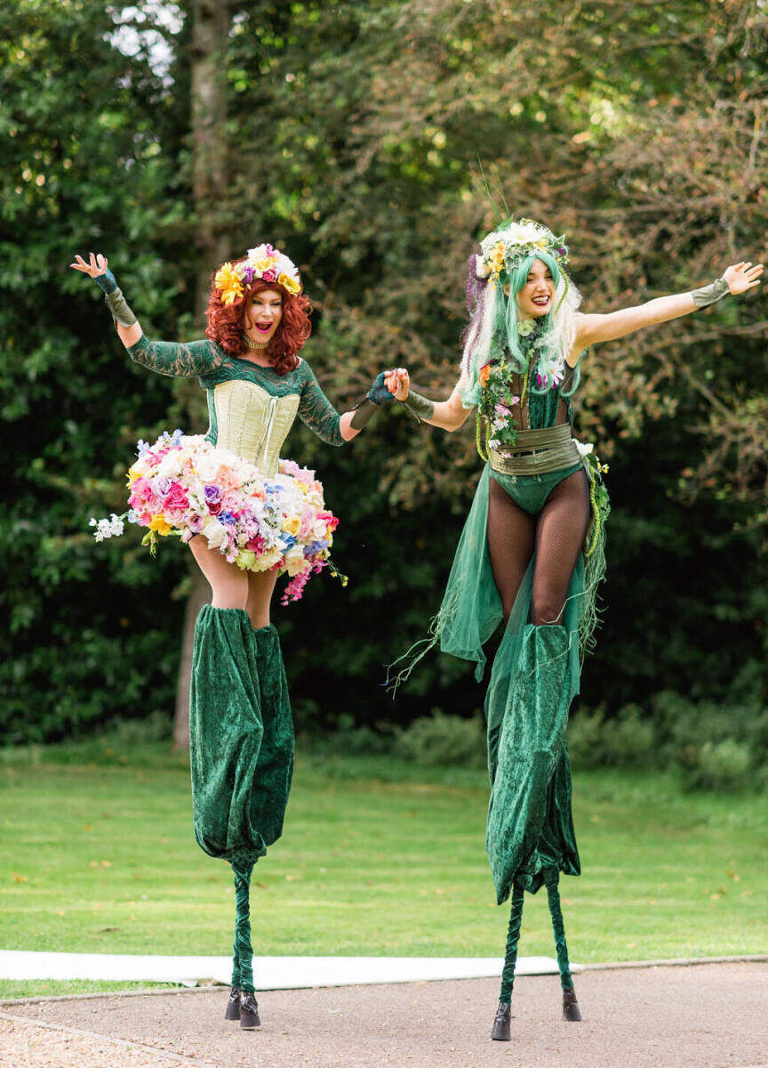 Stilt walkers roamed the grounds of a colorful countryside wedding in Hampshire, England.