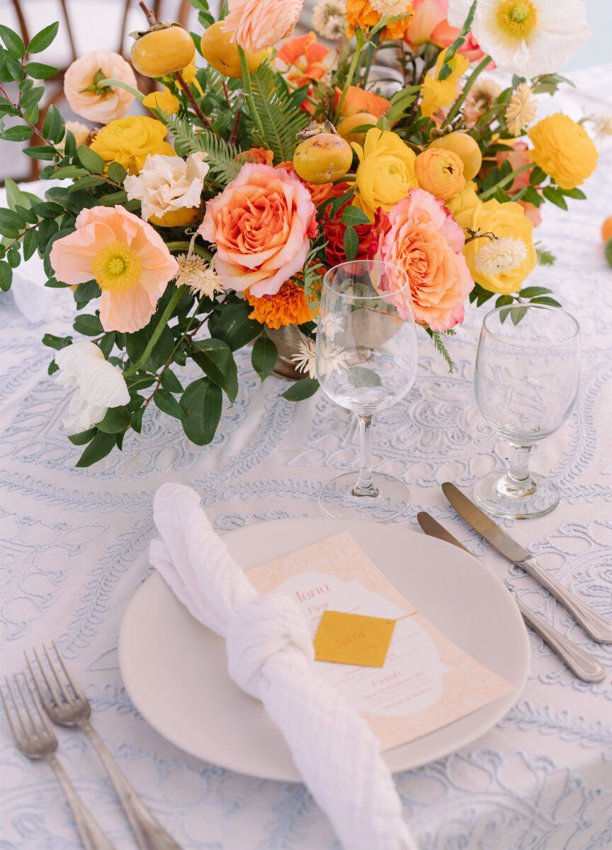 Menus and rolled napkins sat atop each placesetting at an Indian fusion wedding.
