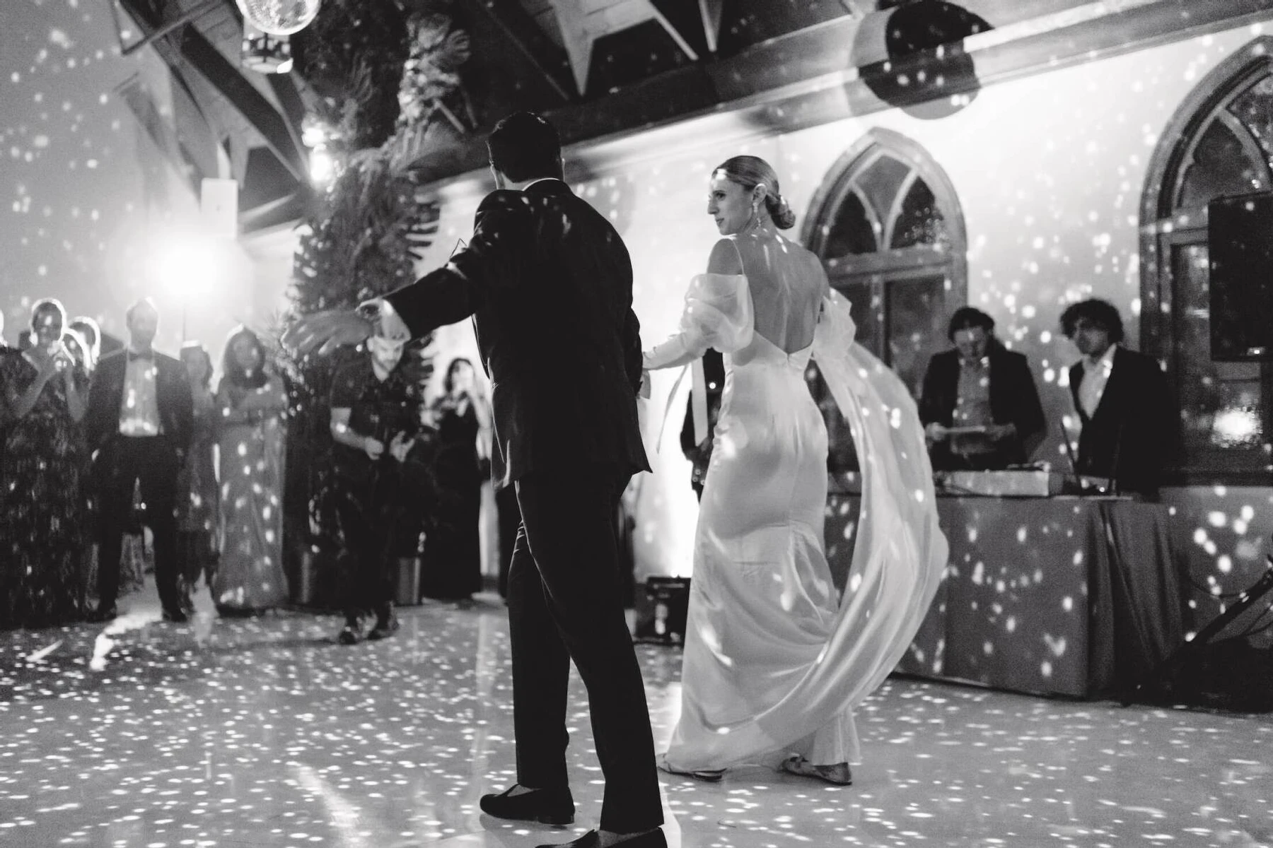 Newlyweds shade a dance on a disco-jungle themed dance floor at their Indian fusion wedding reception.